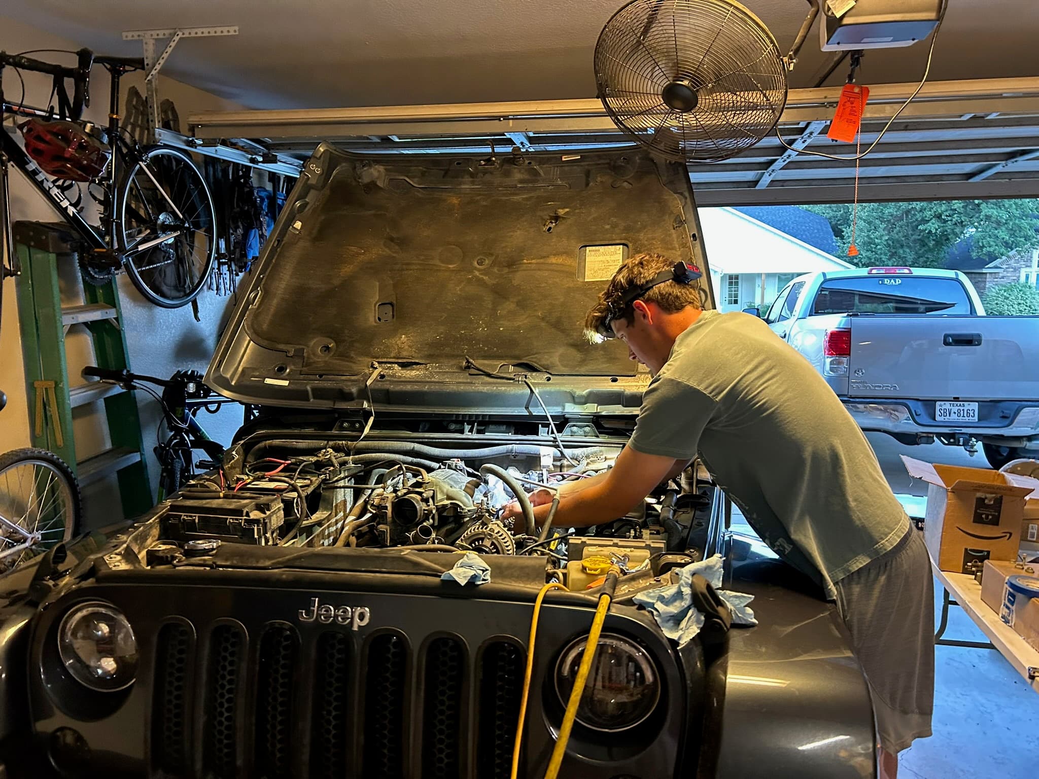 Wrenching on a Jeep in the garage, hood up