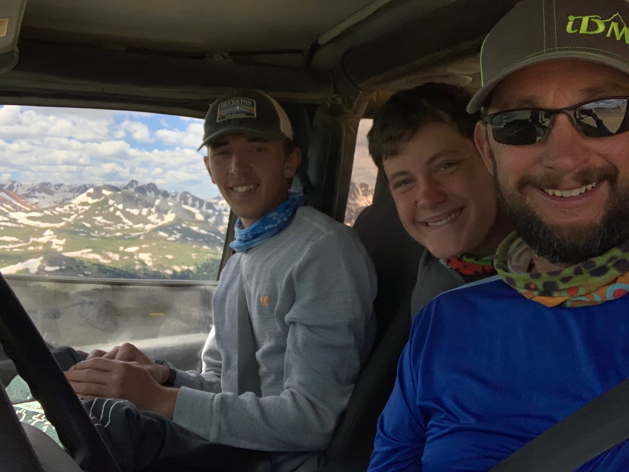 Father and two sons inside a 4Runner with a snow basin out the window