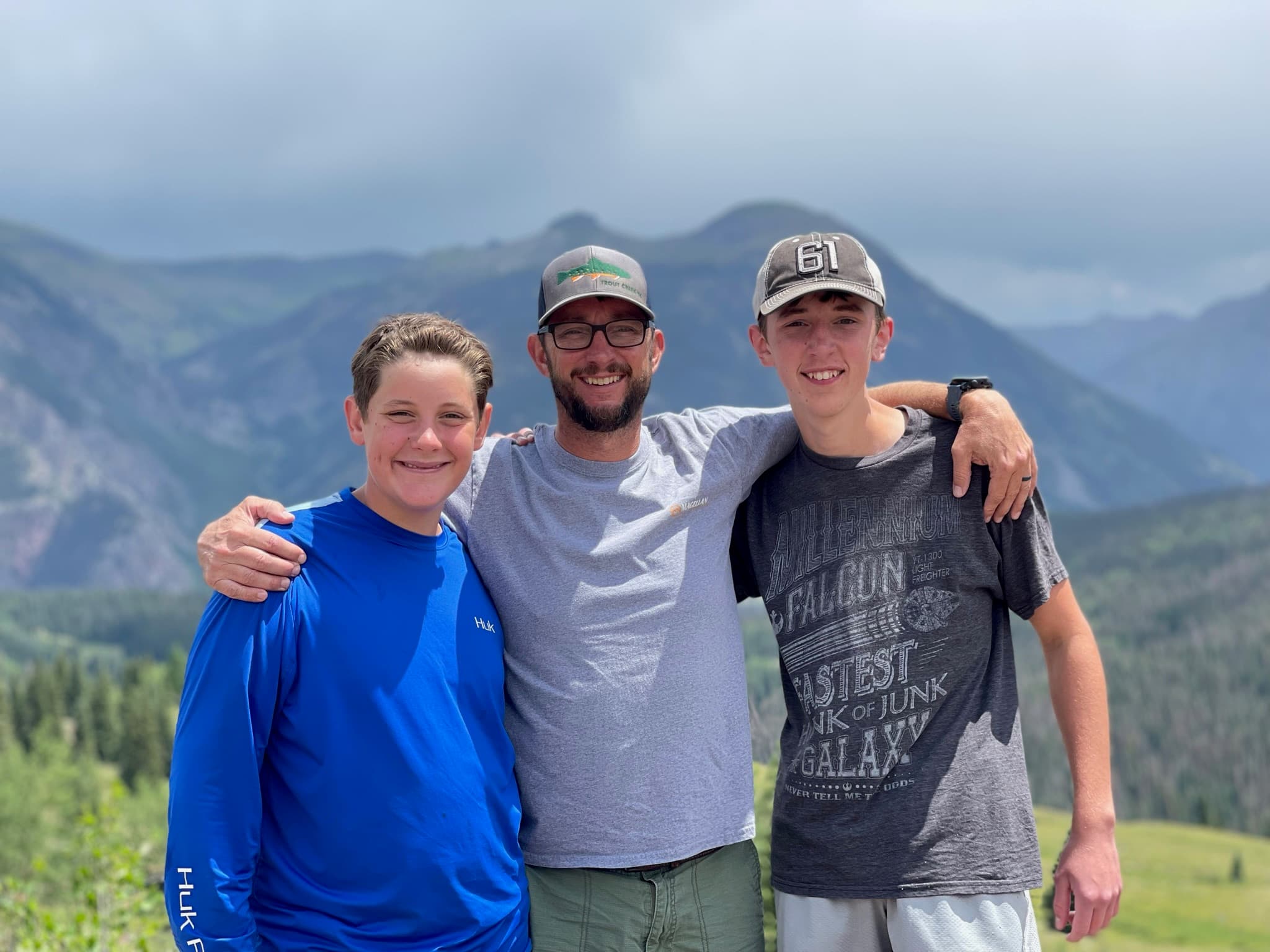 Father and two sons at an alpine overlook