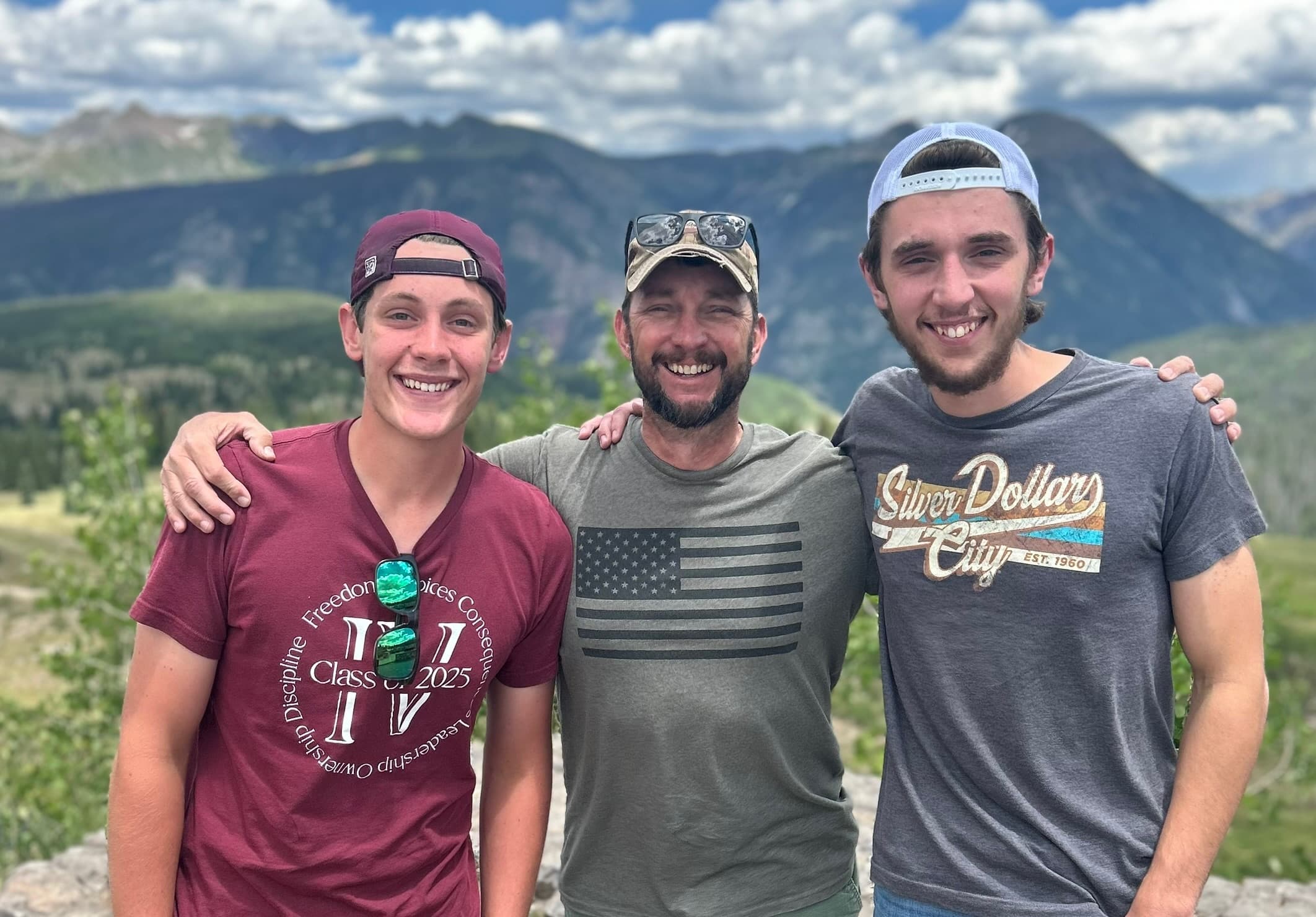 Three men on an alpine viewpoint