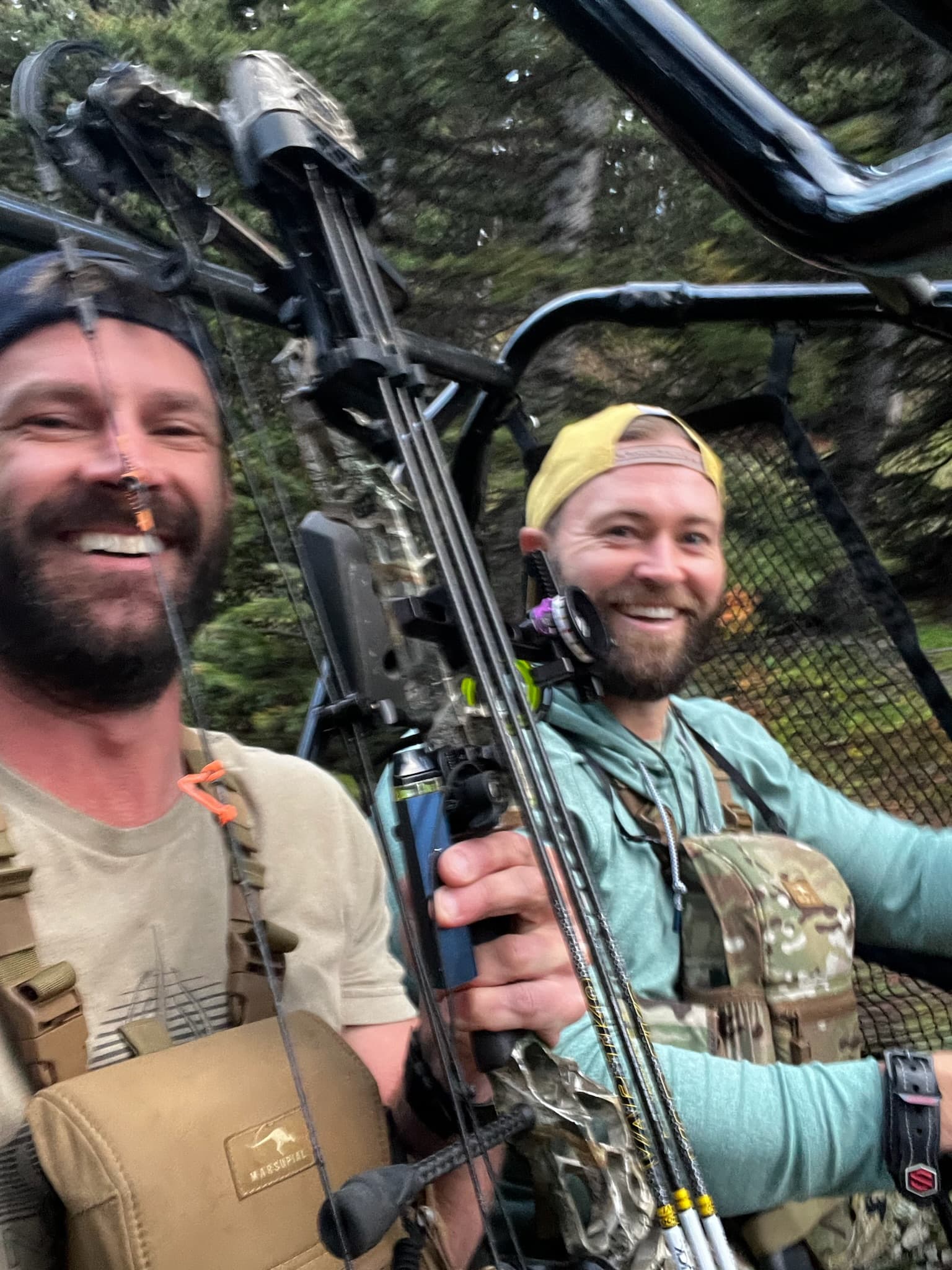 Two bowhunters in a side-by-side, motion blur