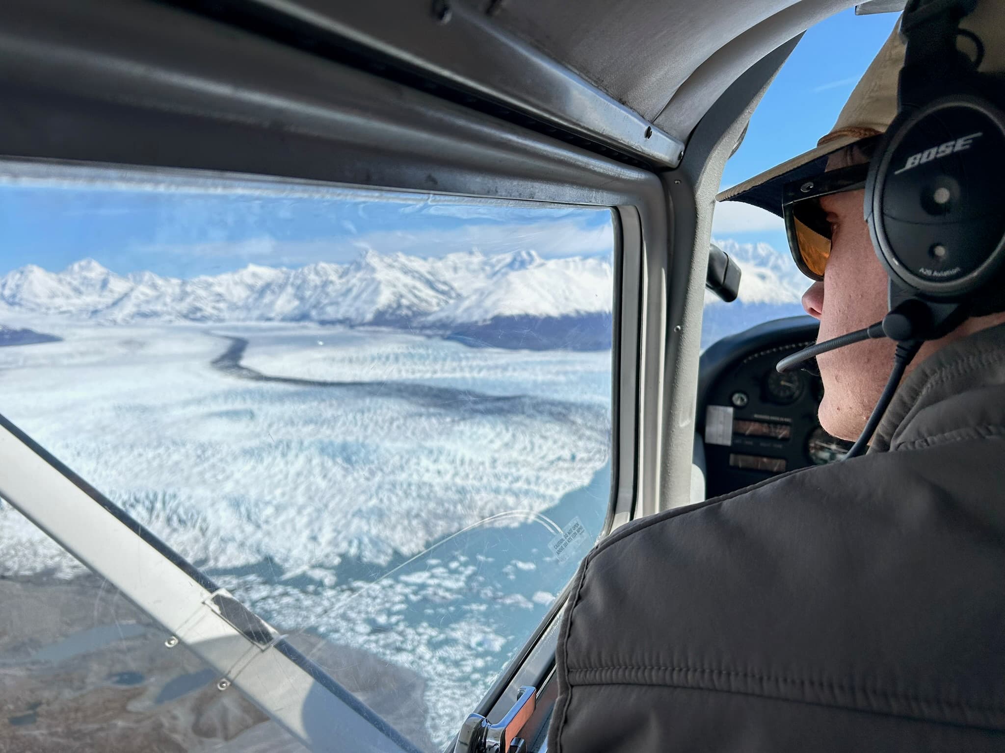 Cockpit window framing an Alaskan glacier